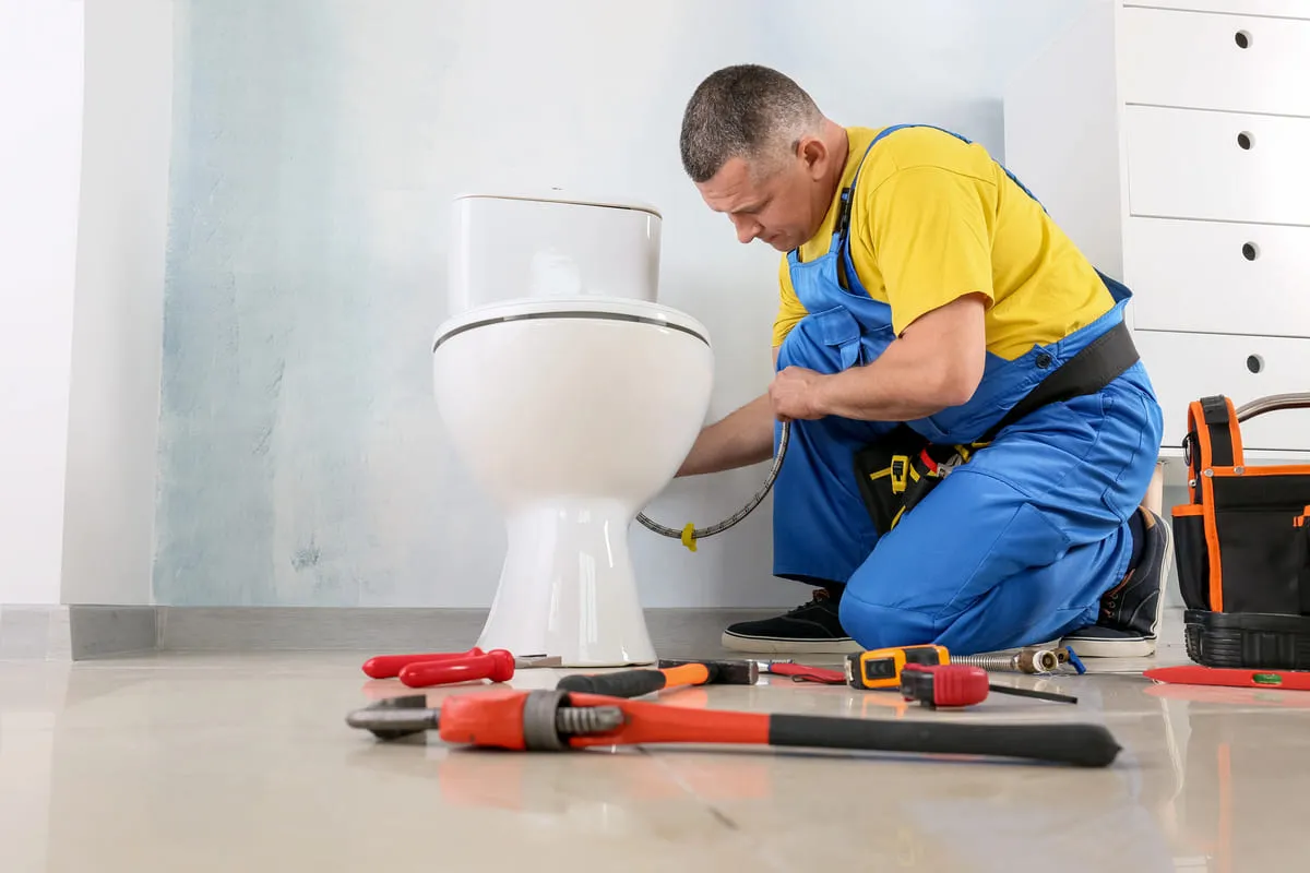 plumber fixing toilet in Toronto